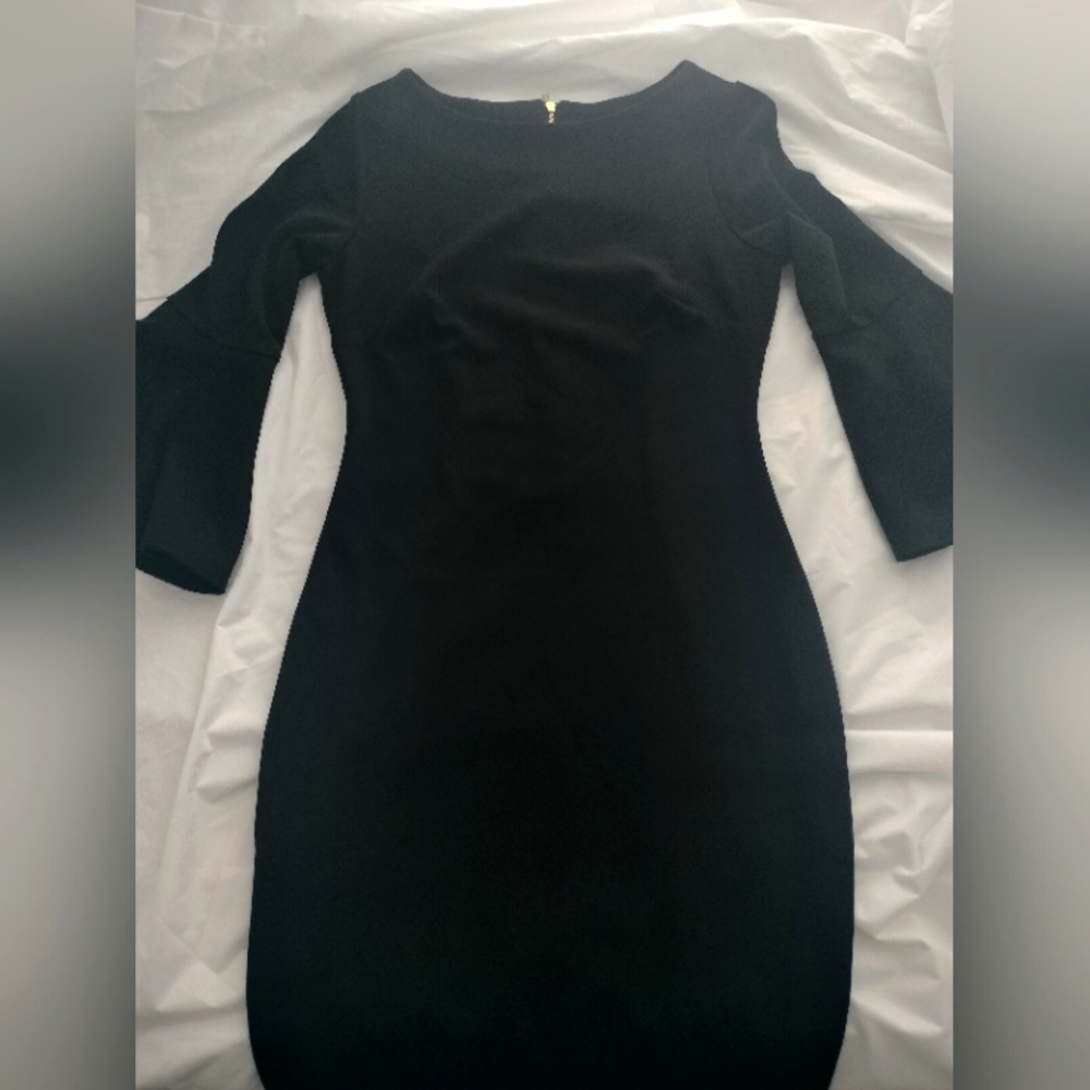A beautiful Calvin Klein long sleeve dress, in size 2. It's in the color black